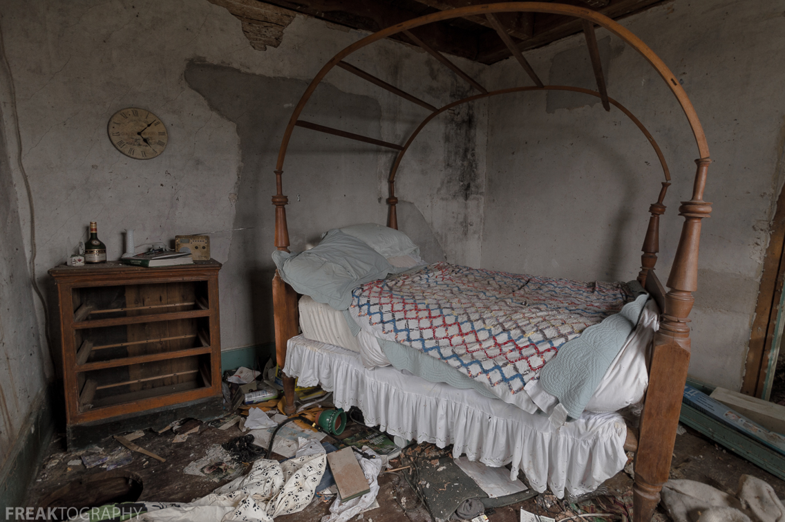 An amazing canopy bed inside an abandoned house in the middle of